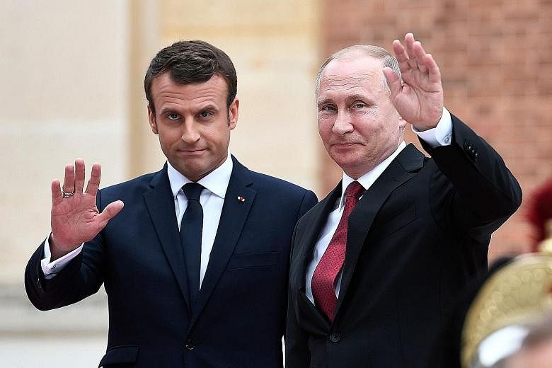 Mr Emmanuel Macron with Mr Vladimir Putin in France last May. Mr Macron arrives in Russia tomorrow for talks with Mr Putin.