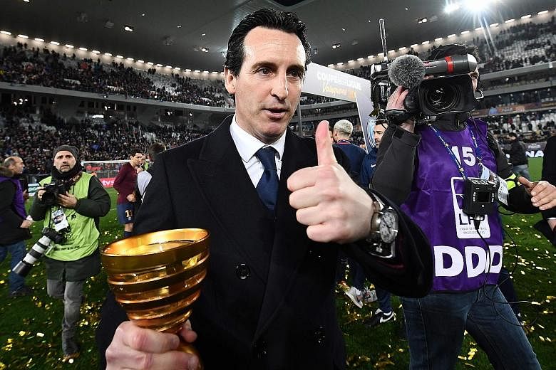 Unai Emery celebrates with the French League Cup trophy after his Paris Saint-Germain side defeated Monaco 3-0 in the final in March. He is understood to have received the thumbs-up from the Arsenal hierarchy and will be appointed their new manager t