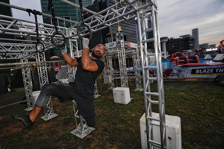 Muhammad Ismail, 35-year-old master coach at Ritual Gym, negotiating an "Insane" level obstacle course during a media preview of the DBS Marina Regatta yesterday.