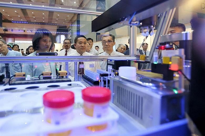 From left: Ms Sun Xueling, Senior Parliamentary Secretary for Home Affairs and National Development, Mr Amrin Amin, Senior Parliamentary Secretary for Home Affairs and Health, and Mr Ng Ser Song, the Central Narcotics Bureau's director, viewing the u