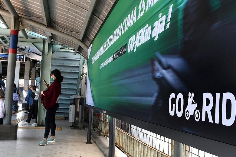 A Go-Jek ad at a railway station in Jakarta. The Indonesian ride-hailing firm said it would spread its services to the Philippines, Singapore, Thailand and Vietnam in the next few months, without specifying any dates.