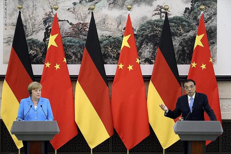 Chinese Premier Li Keqiang speaks during a joint press conference with German Chancellor Angela Merkel after their bilateral meeting at the Great Hall of the People in Beijing yesterday.