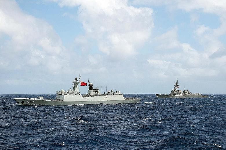 Above: A Chinese frigate and a US guided-missile destroyer at the Rim of the Pacific multilateral maritime war exercise in 2016. Left: Satellite imagery showing what the CSIS Asia Maritime Transparency Initiative calls the deployment of new weapons s