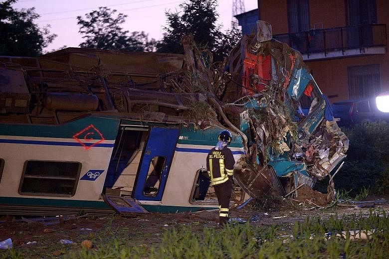The twisted wreckage of the train that ploughed into a truck outside Caluso near Turin, Italy, late on Wednesday. Two people died and 20 were hurt.