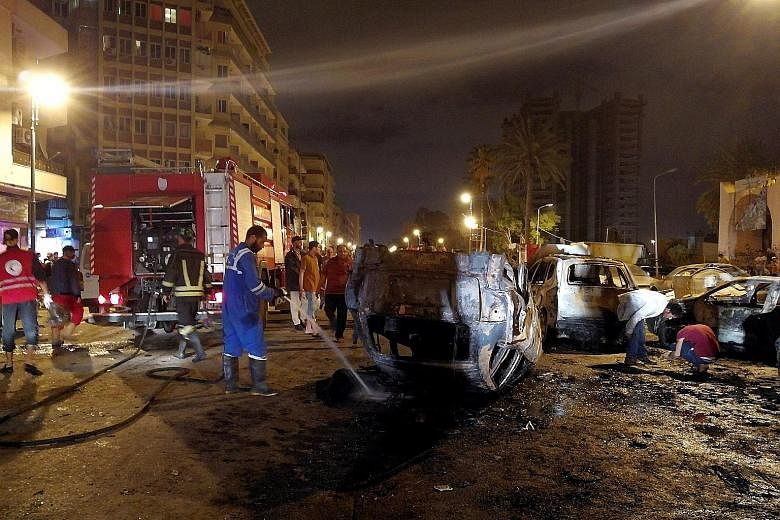 The aftermath of the car bombing in Benghazi on Thursday night, which took place close to the Tibesti hotel on a busy road where many people go to celebrate during the month of Ramadan. No group has yet claimed responsibility for the attack.