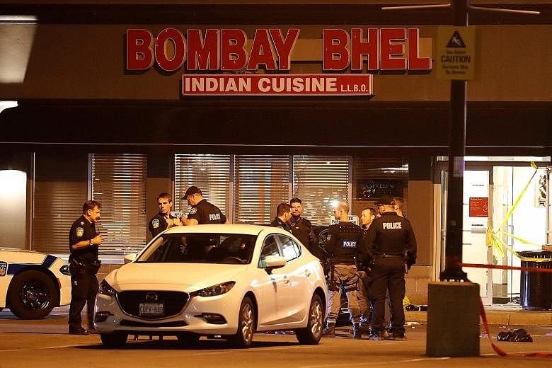Police outside Bombay Bhel restaurant, where two unidentified men set off a bomb on Thursday night, wounding 15 people, in Mississauga, Ontario. Three of the victims had critical injuries. No one has claimed responsibility, and the motive for the att