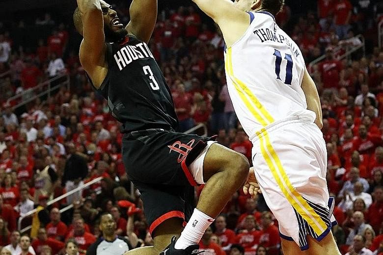 Houston's Chris Paul going up for a shot as Golden State's Klay Thompson defends in Game Five of the NBA Western Conference Finals at Toyota Centre. Houston's 98-94 victory means they can eliminate the defending champions tonight in Oakland.