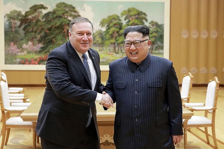 Left: North Korean leader Kim Jong Un and US Secretary of State Mike Pompeo meeting on May 8 at the Workers' Party of Korea headquarters in Pyongyang, in this photo released by North Korea's official Korean Central News Agency (KCNA). Mr Pompeo, who 