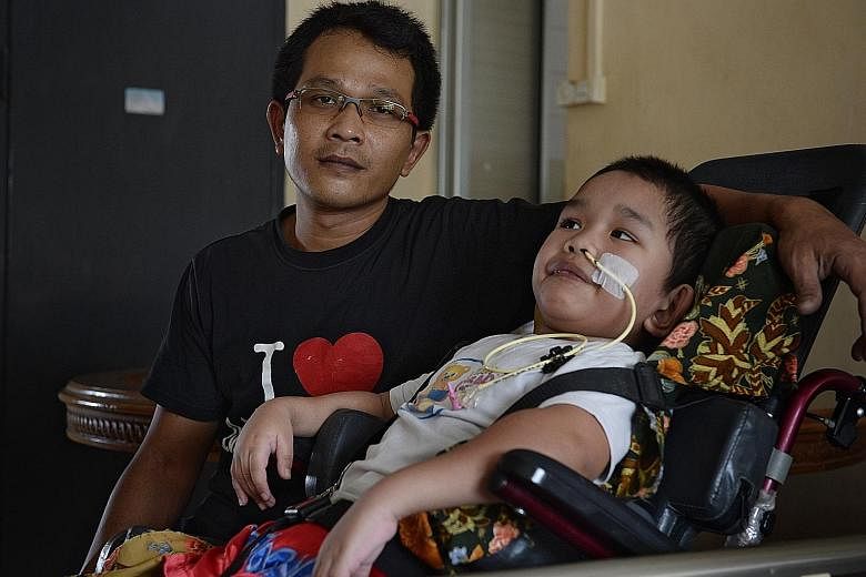 Mr Abdul Halim Abdul Aziz with his son Syahriz Matin in a 2016 photo. Syahriz was found submerged face downwards in the wave pool of the Civil Service Club's Bukit Batok swimming facility on Oct 11, 2015, and suffered traumatic brain injury. Now 10, 