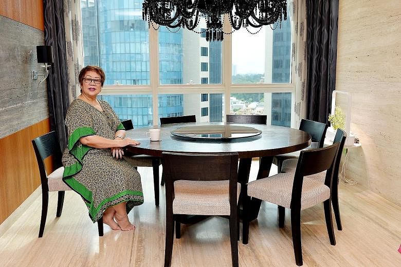 Businesswoman Greta Ng relaxing in her house, which boasts spectacular views. Besides Ganbanyoku Hot Stone Therapy spa at Far East Plaza, Ms Ng has a property portfolio including a 4,000 sq ft two-storey house in Bukit Timah Road and a 1,200 sq ft ap