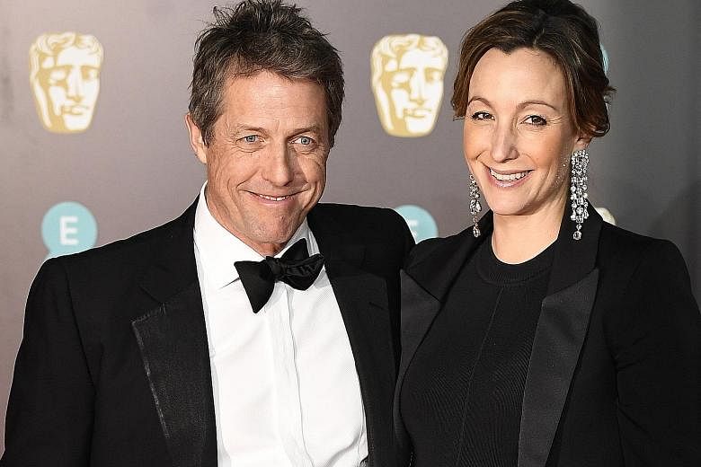 British actor Hugh Grant and producer Anna Eberstein in a February photo. Grant, who has played a string of commitment-phobic characters, married Eberstein at a low-key civil ceremony in London last Friday.
