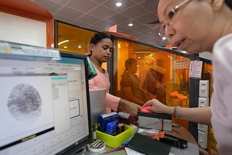 A new maid having her thumb print taken during registration for her work permit at the MOM Services Centre last Tuesday. As of last year, Singapore has 240,000 maids. New maids attending a Settling-In Programme. Last year, the Manpower Ministry punis