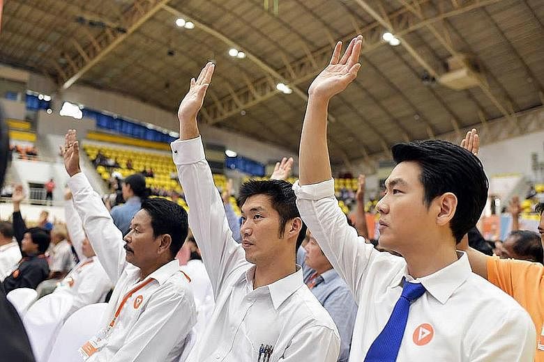 Tycoon Thanathorn Juangroongruangkit (centre) and Thammasat University law lecturer Piyabutr Saengkanokkul (right) hope to lead Future Forward in elections slated for next February.