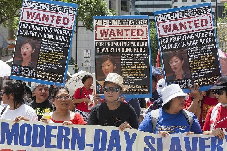 Foreign domestic workers from the Philippines and Indonesia at a rally in Hong Kong yesterday to protest comments by Ms Eunice Yung, a Hong Kong Legislative Councillor from the New People's Party. Earlier in the week, in the Legislative Council, Ms Y