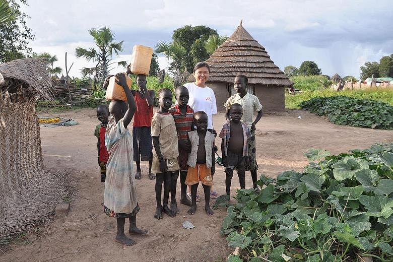 Miss Lim Suet Fong with a group of village children in Pibor, South Sudan, when she was a field worker with Doctors Without Borders. The civil engineer says she has "gained a lot more than what I have given" during her two missions - in South Sudan a