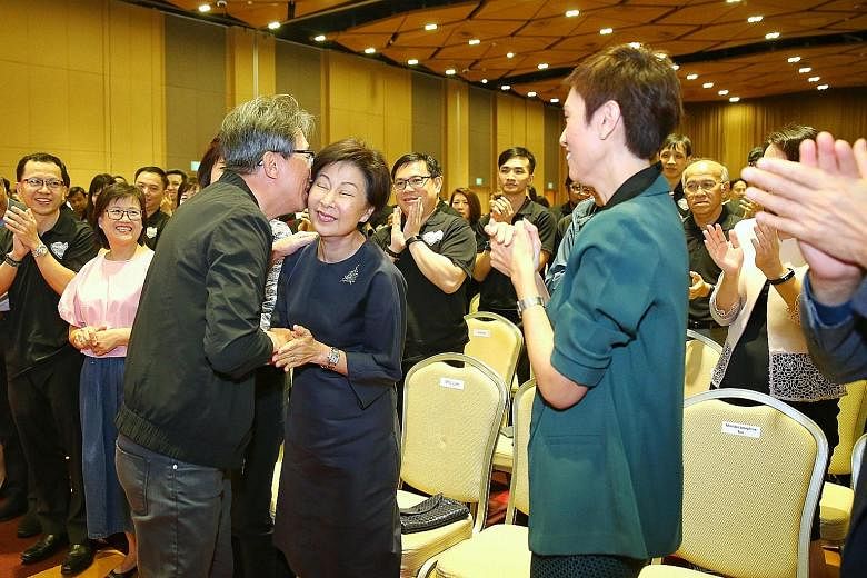 Right: Former manpower minister Lim Swee Say holding a miniature figure of himself that was presented to him. Far right: Mr Lim kisses his wife after giving a speech, as current Manpower Minister Josephine Teo looks on.