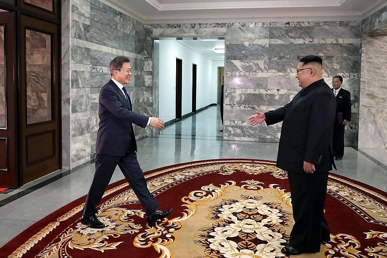 South Korean President Moon Jae In (far left) greeting North Korean leader Kim Jong Un before their second summit at the truce village of Panmunjom, on Saturday, in a handout photo released by South Korea's presidential Blue House yesterday. The US-S