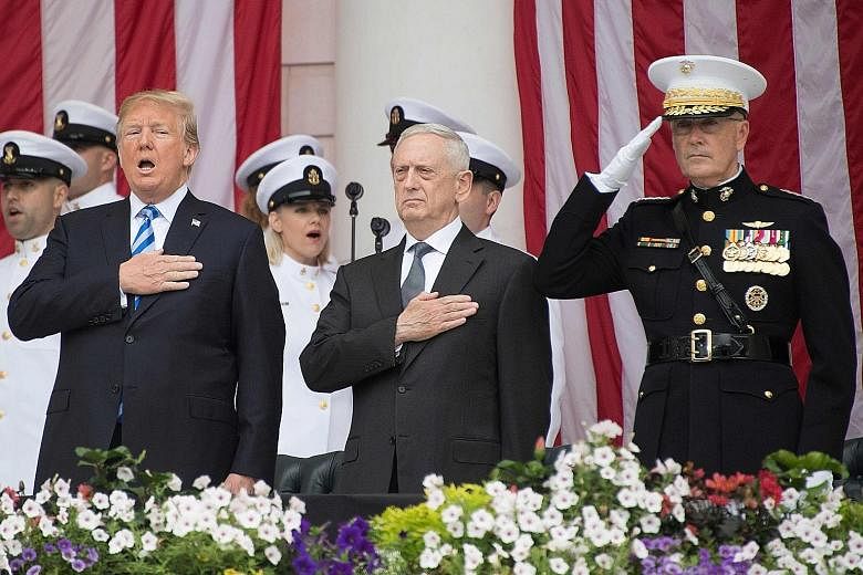 From left: US President Donald Trump, with US Secretary of Defence James Mattis and Chairman of the Joint Chiefs of Staff General Joseph Dunford, singing the national anthem during a Memorial Day ceremony at Arlington National Cemetery in Arlington, 