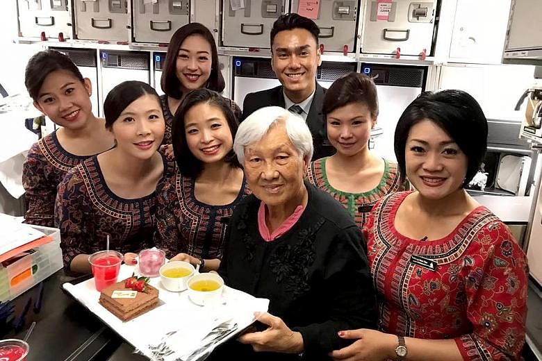 Madam Lye wore a special kebaya with gold details when the crew served the Sultan of Brunei on a flight in 1964. Madam Susan Lye holding a photo of her days as an air stewardess with the former Malayan Airways, which was later rebranded as Malaysia-S