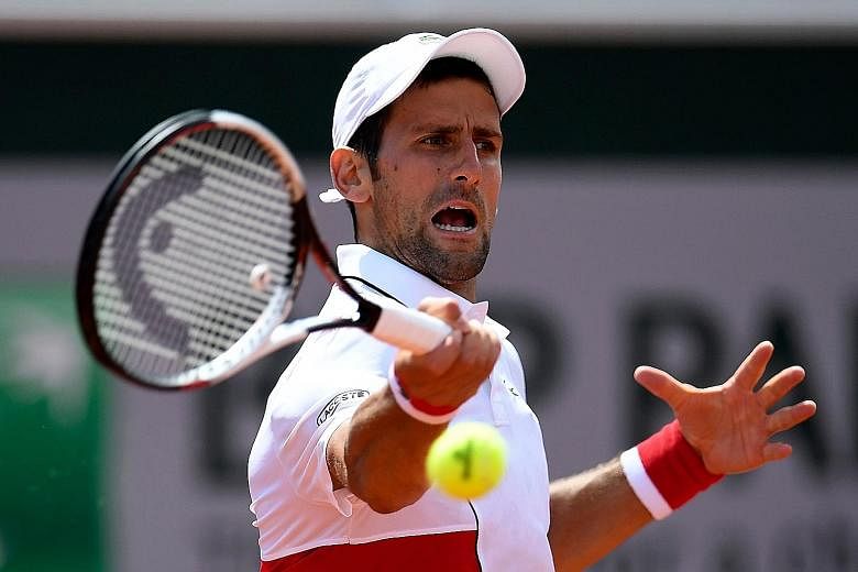 Novak Djokovic hits a forehand during his 7-6 (7-1), 6-4, 6-4 second-round win over Spanish qualifier Jaume Munar at the French Open yesterday. His next opponent will be another Spaniard, Roberto Bautista Agut.