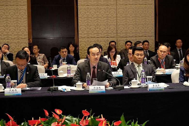 Senior Minister for State for Trade and Industry Koh Poh Koon speaking at the Singapore-Nanjing Special Projects Cooperation Panel in Nanjing yesterday. Next to him is Mr Lee Yi Shyan, a member of the Singapore delegation. Dr Koh witnessed the signin