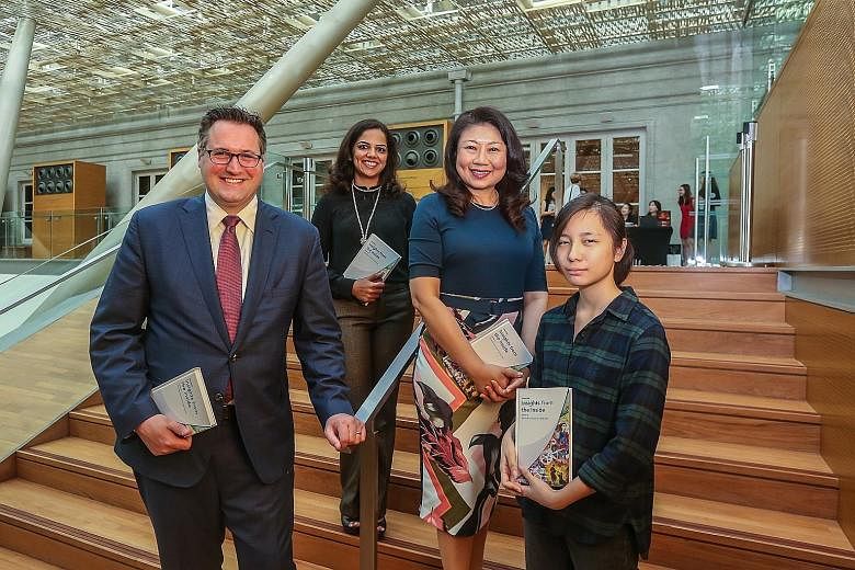 Contributors to Singapore: Insights From The Inside (from left) Matthew Herrmann, Divya Patel and Chong Siak Ching with Ms Amelia Tan, one of the illustrators for the book, at the National Gallery Singapore on Wednesday.