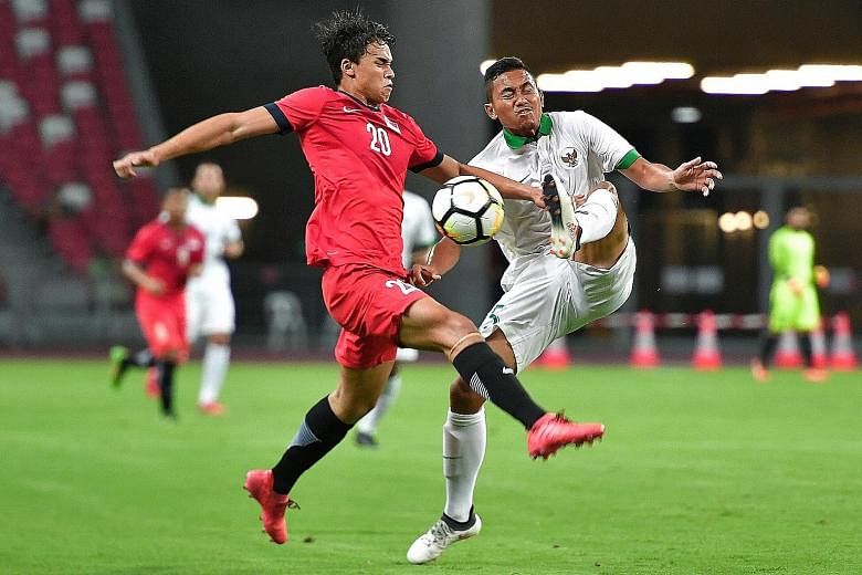 Singapore's Ikhsan Fandi squaring off with Indonesia's Ricky Fajrin Saputra at the National Stadium in March, when the home side were beaten 3-0. The Republic's football team competed at the past three Asian Games - 2006, 2010 and 2014 - but made the