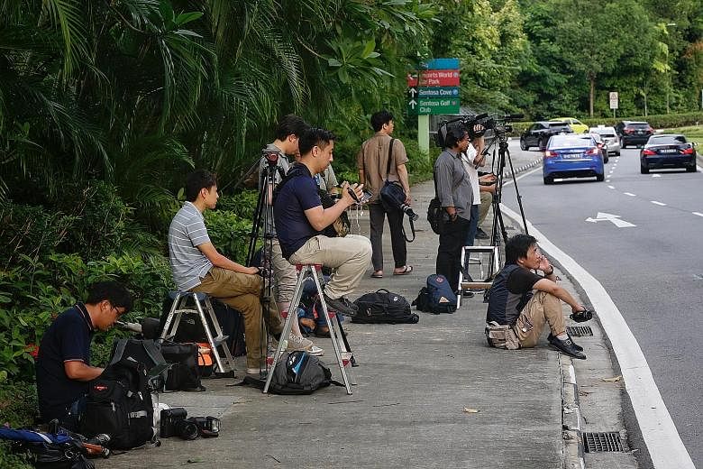 Foreign media personnel, mostly from Japan, staking out a road leading to the Capella Hotel on Sentosa on Wednesday, where the American delegation has been staying. At least 2,000 media personnel are expected to cover the proposed Trump-Kim summit.