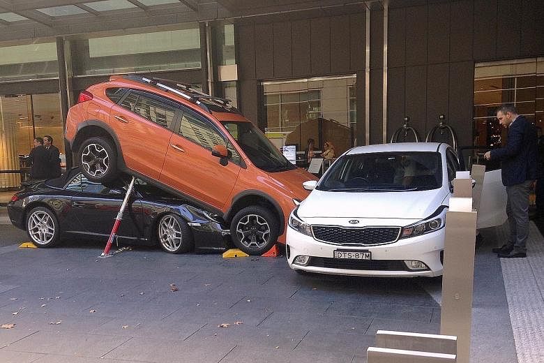 The accident occurred near the Hyatt Regency Sydney yesterday. The valet was trying to park the Porsche when, instead of reversing, the car reportedly accelerated into the back of the Subaru SUV and ended up under it instead.