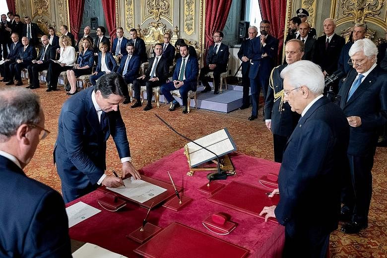 Italian Prime Minister Giuseppe Conte (left) with President Sergio Mattarella during the swearing-in ceremony for the new government yesterday. Mr Conte will head a government made up of ministers from the anti-establishment Five Star Movement and th
