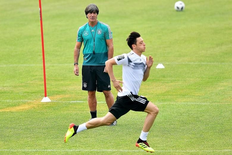 Germany coach Joachim Low keeping a watchful eye on Mesut Ozil at their training camp in Eppan, Italy this week. Low recently extended his contract with the German national team until the 2022 World Cup and is confident Real Madrid will find the righ