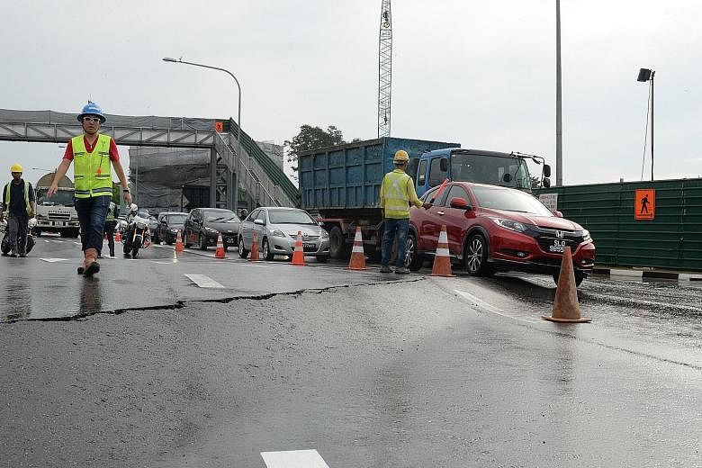 The cracks on Adam Road, which developed next to a huge excavation for the construction of an underpass that will be part of the Bukit Brown road, were discovered at 8am yesterday. They led to extensive congestion during the morning rush hour, with t