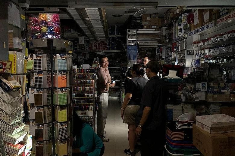 Businesses from eateries to corporate offices were affected by the power outage yesterday. Some shopkeepers said that they had difficulty serving customers as their cash registers relied on electricity. Buildings such as Chinatown Point and The Arcad