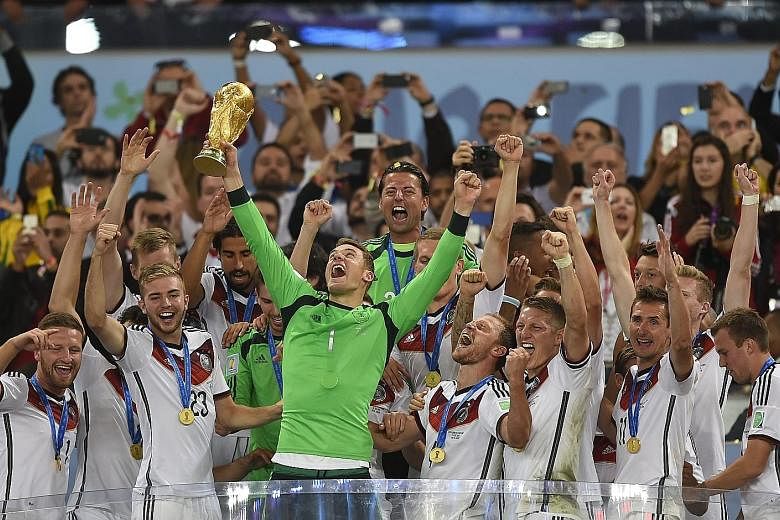 Germany goalkeeper Manuel Neuer lifting the World Cup trophy at the Maracana in 2014 after the 1-0 extra-time victory over Argentina. The captain is back from injury to lead Germany's title defence.
