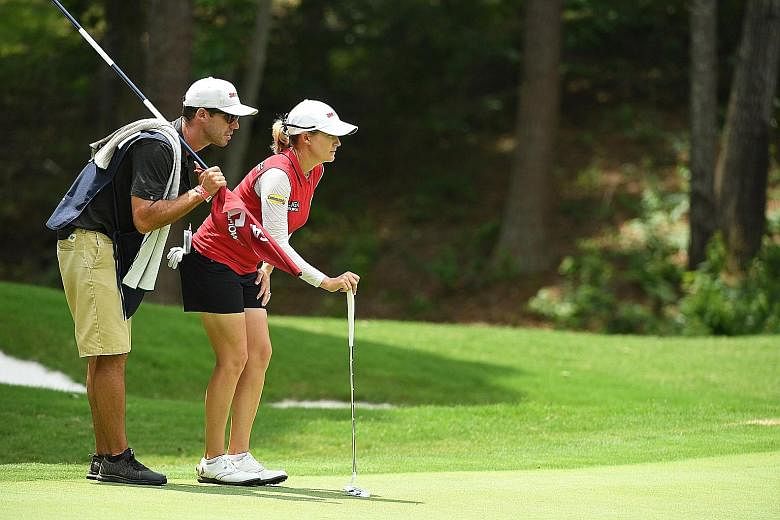 Sarah Jane Smith looking over the seventh green with caddie and husband Duane, during the second round of the US Women's Open Championship golf tournament at Shoal Creek on Friday.