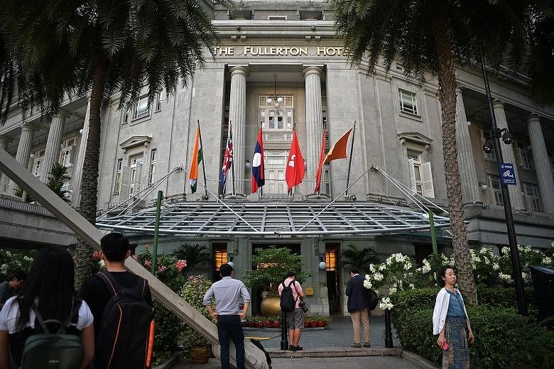 Foreign media (far left) staking out the road that leads to Capella Hotel on Sentosa, where the summit between US President Donald Trump and North Korean leader Kim Jong Un is likely to be held. Mr Kim could stay at The Fullerton Hotel (left) during 