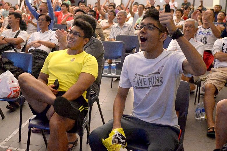 The audience at the Bedok Community Centre reacting to England's equaliser at the 3am live screening of their World Cup 2014 defeat by Uruguay.