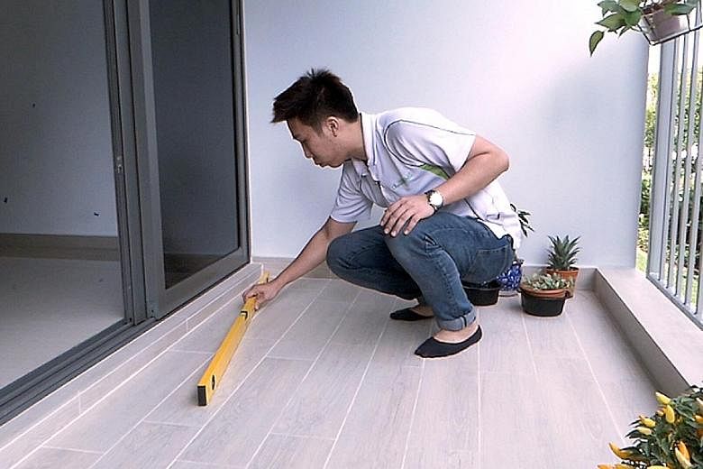 Defect inspectors conduct a number of checks, as shown by Advance Inspection's lead inspector Joelson Sim. From top: Mr Sim demonstrating the use of a spirit level to check the gradient of the floor. He checks the drainage for any debris that might l