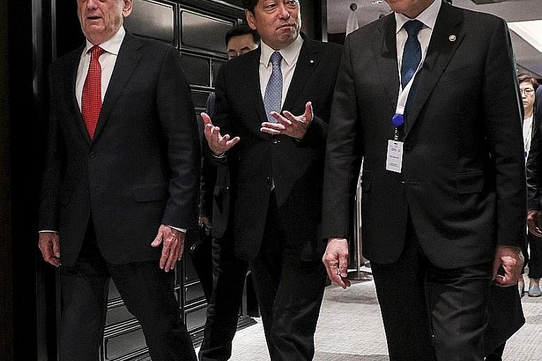 From far left: US Defence Secretary James Mattis, Japanese Defence Minister Itsunori Onodera and South Korean National Defence Minister Song Young Moo after a trilateral meeting on the sidelines of the Shangri-La Dialogue yesterday. Mr Mattis warned 