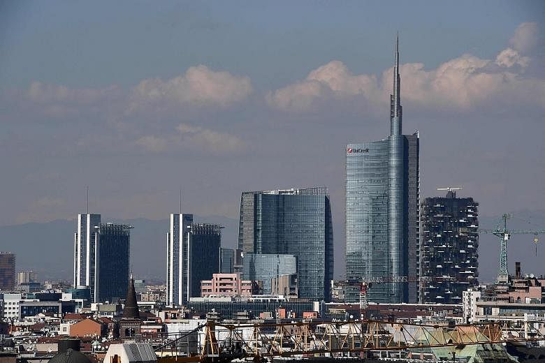 The UniCredit building (right) in the Porta Nuova district in Milan. UniCredit is Italy's largest bank by assets, while Societe Generale is France's second-biggest lender.