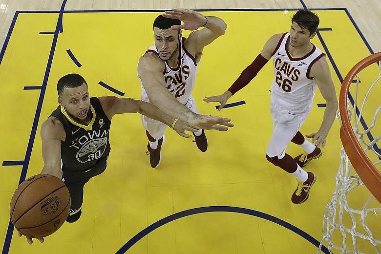Stephen Curry of the Golden State Warriors driving to the basket against Larry Nance (No. 22) and Kyle Korver of the Cleveland Cavaliers in the second half of Game Two of the NBA Finals on Sunday. Curry finished with 33 points, converting nine of 17 