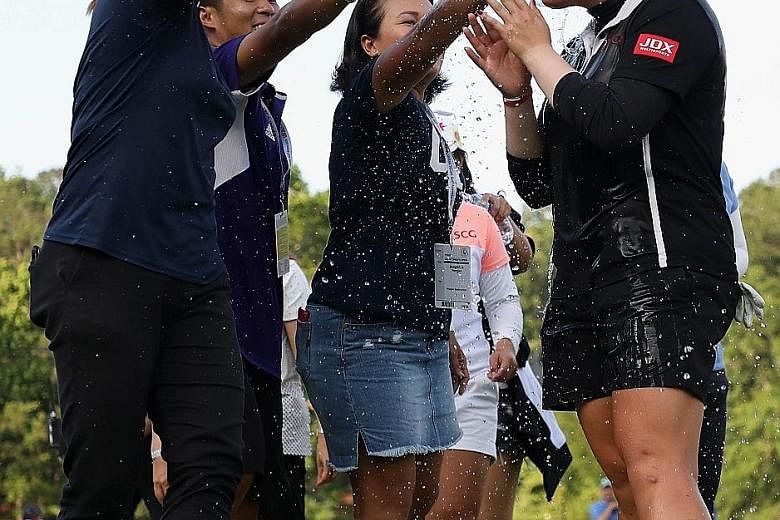 Ariya is doused with water by members of her entourage in celebration of her second Major title victory.