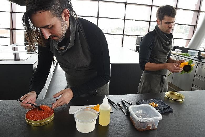 Chef Jordan Kahn (above) prepares a dish of rice pudding and trout roe at his restaurant, Vespertine, in Culver City, California.