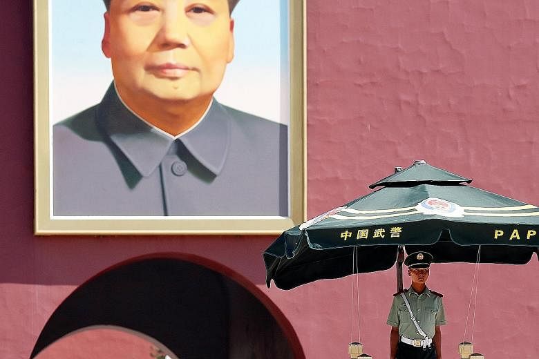 A paramilitary policeman keeping watch underneath the portrait of former Chinese chairman Mao Zedong in Beijing's Tiananmen Square yesterday, the anniversary of the June 4, 1989 crackdown on protests.
