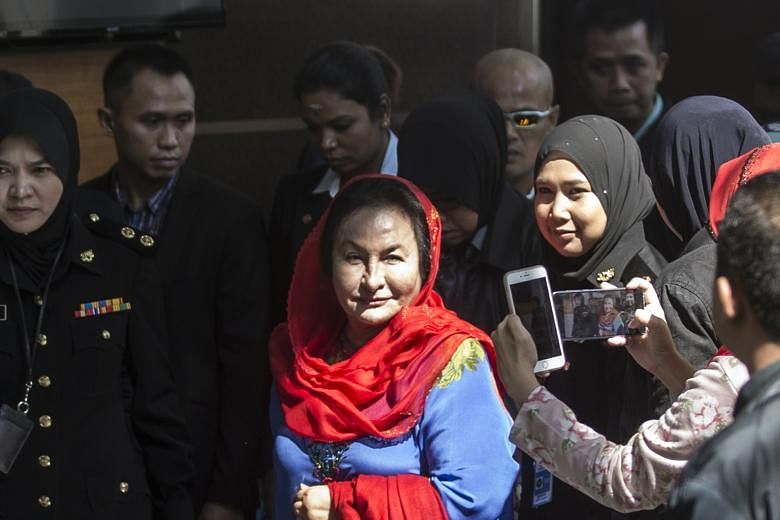 Datin Seri Rosmah Mansor being escorted by the authorities after she arrived at the Malaysian Anti-Corruption Commission in Putrajaya yesterday morning. She was questioned for five hours.