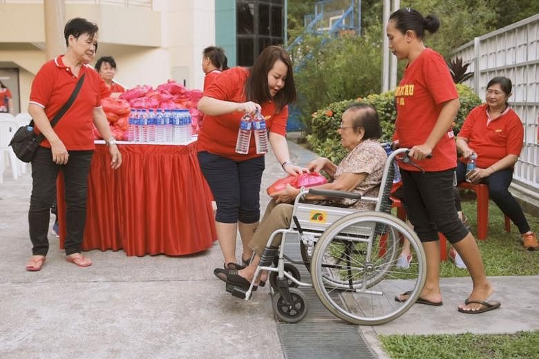 Miss Goh giving out water at a community event for the elderly at Fengshan Community Club in April. Through Ms Soh, Miss Goh became interested in grassroots activities and she now volunteers regularly.
