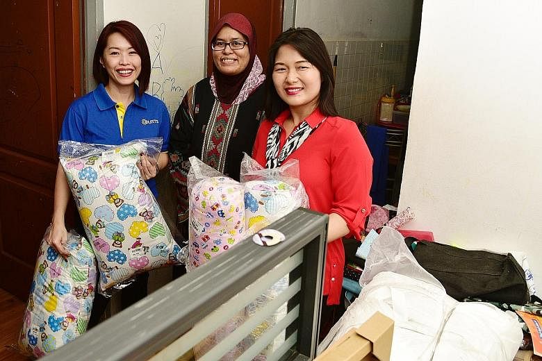 Madam Siti Norbayah (centre), like the other 21 low-income Muslim families in Serangoon and Ang Mo Kio, received furniture and appliances from Courts. Madam Siti is seen here with Courts Singapore marketing director Joanna Ho (left) and adviser to Al