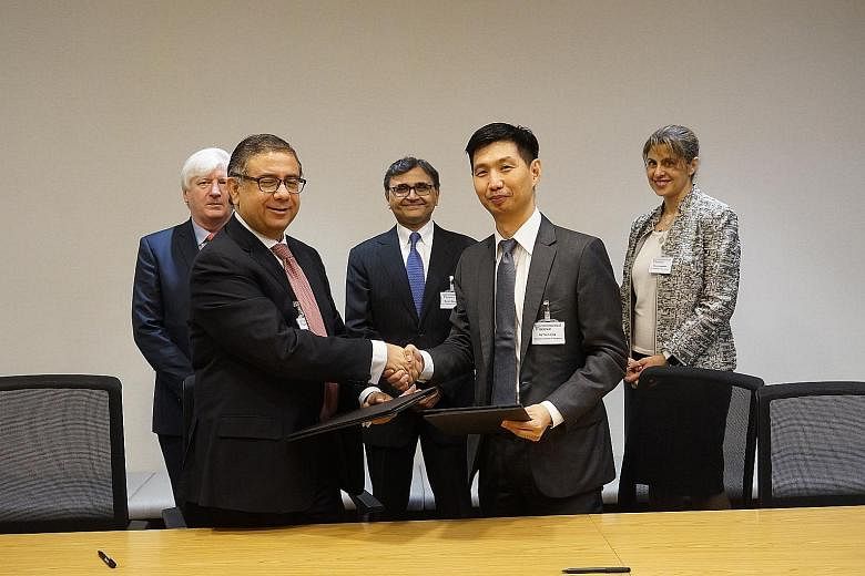 Mr Vivek Pathak, IFC's director for East Asia and the Pacific, and Mr Ng Yao Loong, MAS' assistant managing director, development and international group, at the signing of a memorandum of understanding, which will see both parties working together t