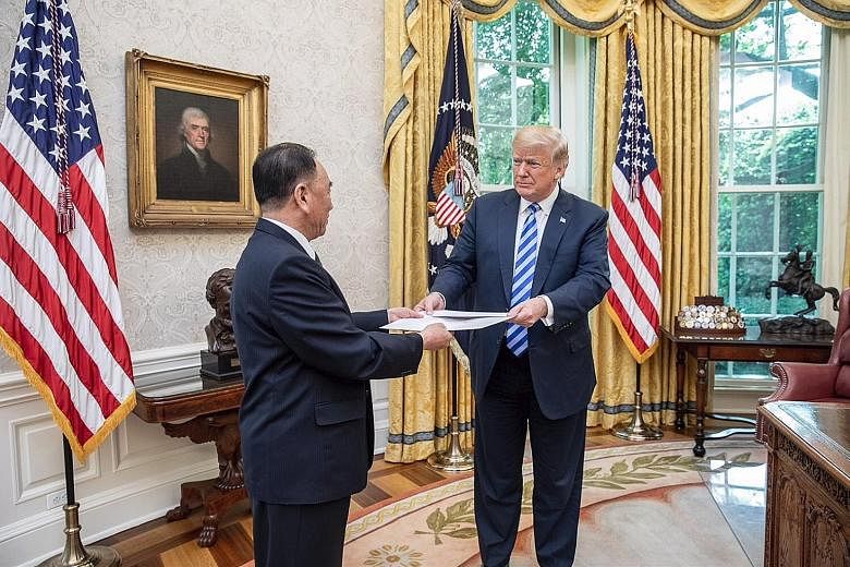 General Kim Yong Chol, vice-chairman of DPRK's Workers' Party of Korea central committee, handing a letter from North Korean leader Kim Jong Un to US President Donald Trump at the Oval Office at the White House in Washington on June 1.