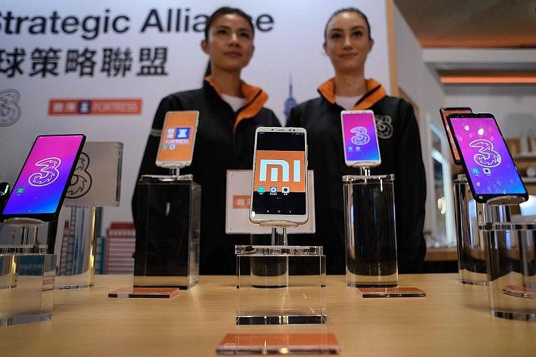 Xiaomi's smartphones on display in Hong Kong. The Beijing-based firm is said to be seeking about US$10 billion (S$13.4 billion) from its IPO. It was the first to file for a Hong Kong IPO with a weighted-voting rights structure after the city's bourse